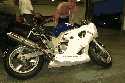 This is a shot that shows the fairing damage due to scraping around the Indy Circuit at Brands Hatch, 7-7-2005.  Ground clearance is a major issue on this bike.  Unofficially running 54 second laps.